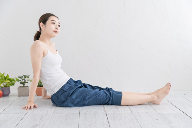 Asian young woman doing mild exercise in a bright room